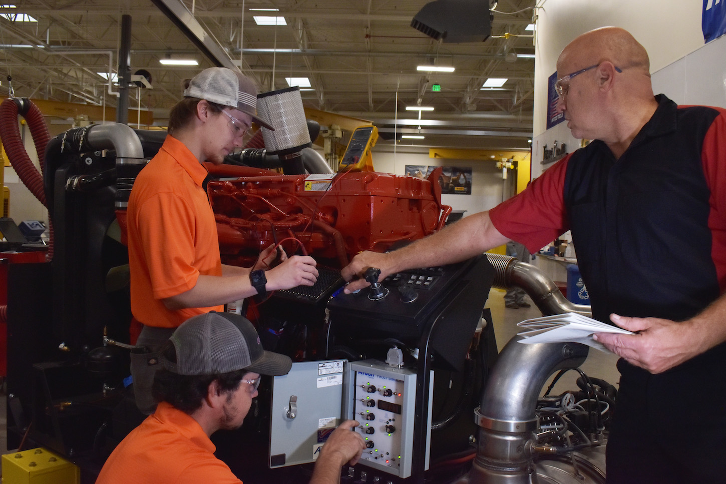 Students work on a diesel trainer