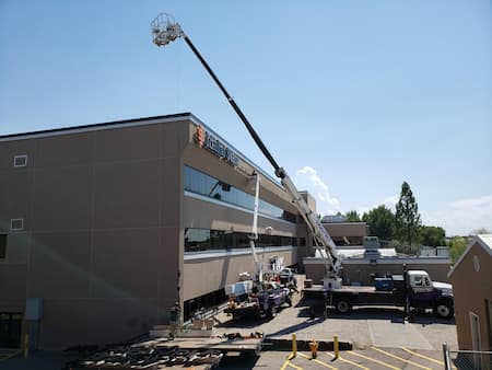 Installing Idaho State's sign on the building