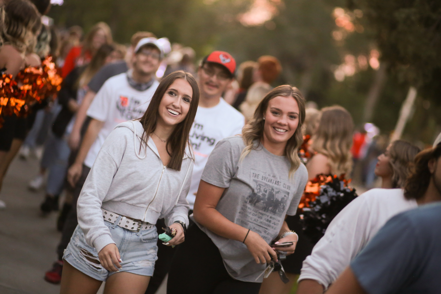 Two smiling women walk on ISU's Campus