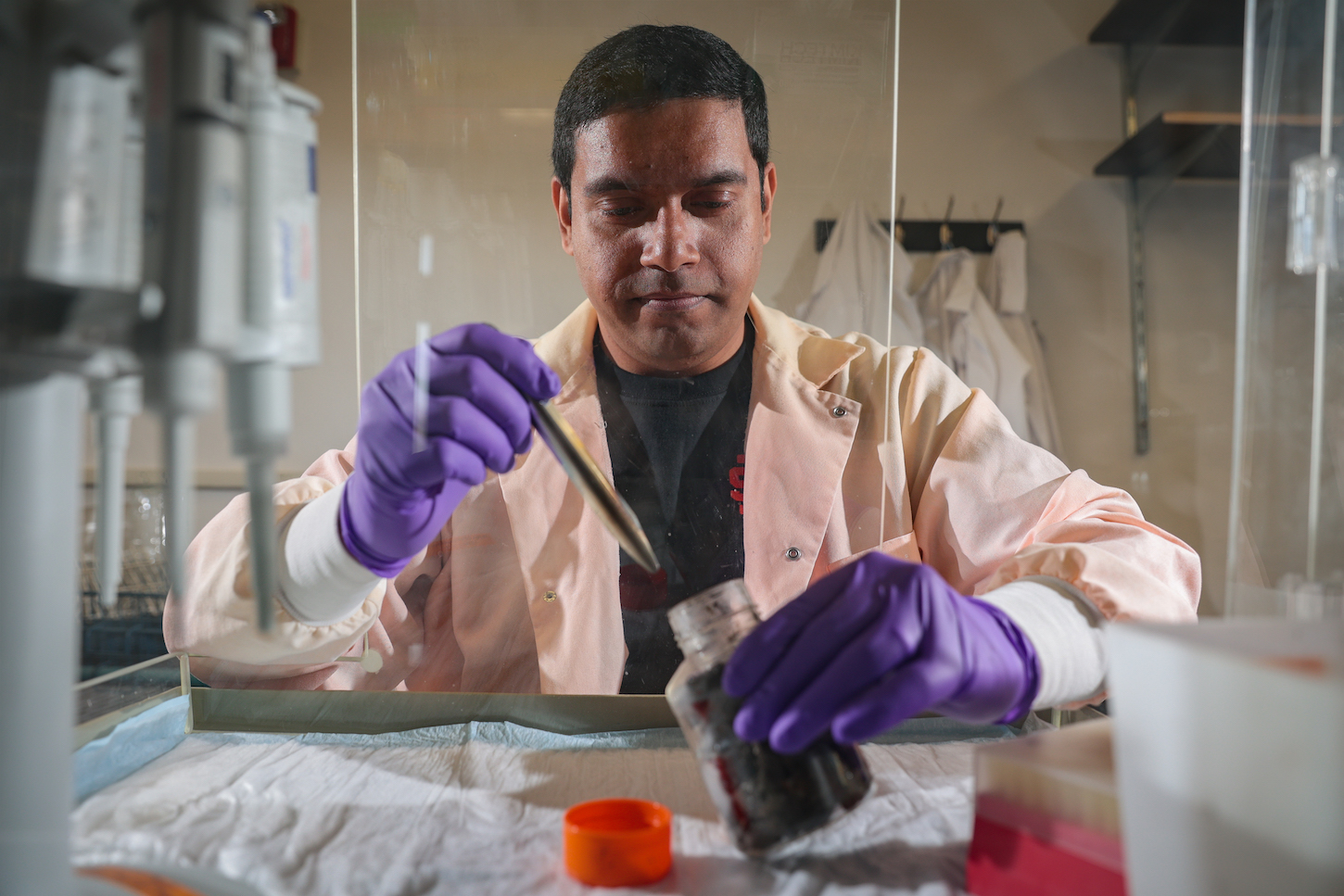 A man works with a beaker