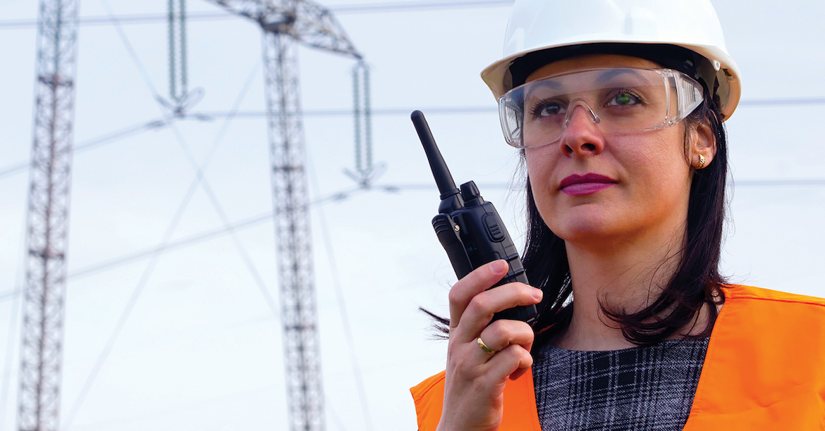 A woman holding a walkie talkie