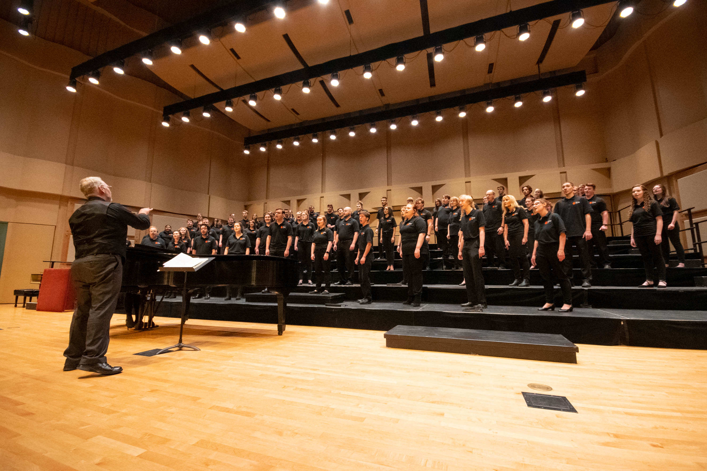 The ISU choir on stage at the Jensen Grand Concert Hall singing