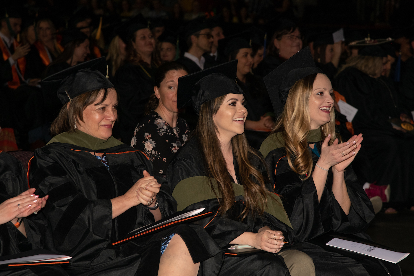 Three women listen to a speaker