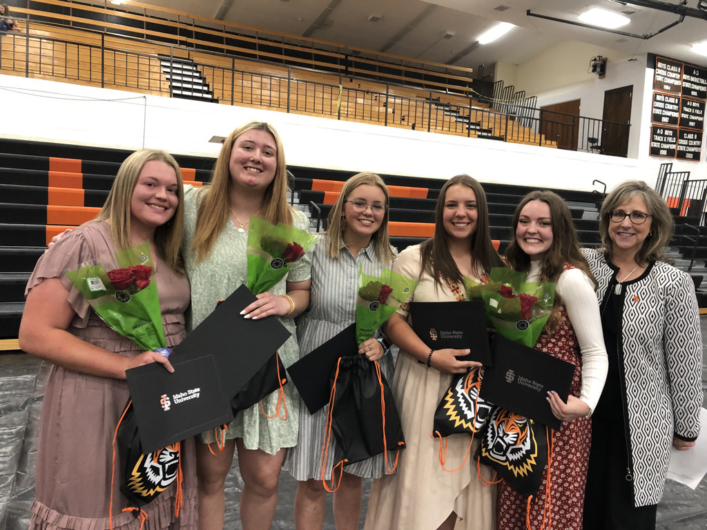 A group of girls stand with Kandi Turley Ames