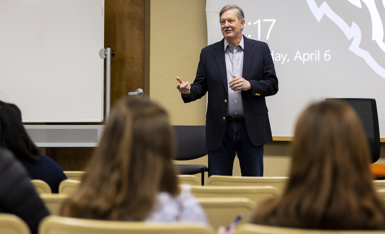 Don Burdick lectures in front of a class of students