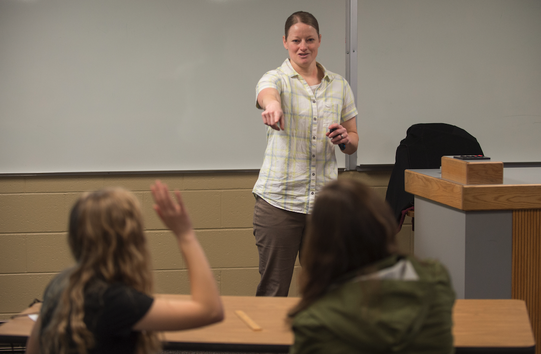 A student teacher from the College of Education in front a classroom