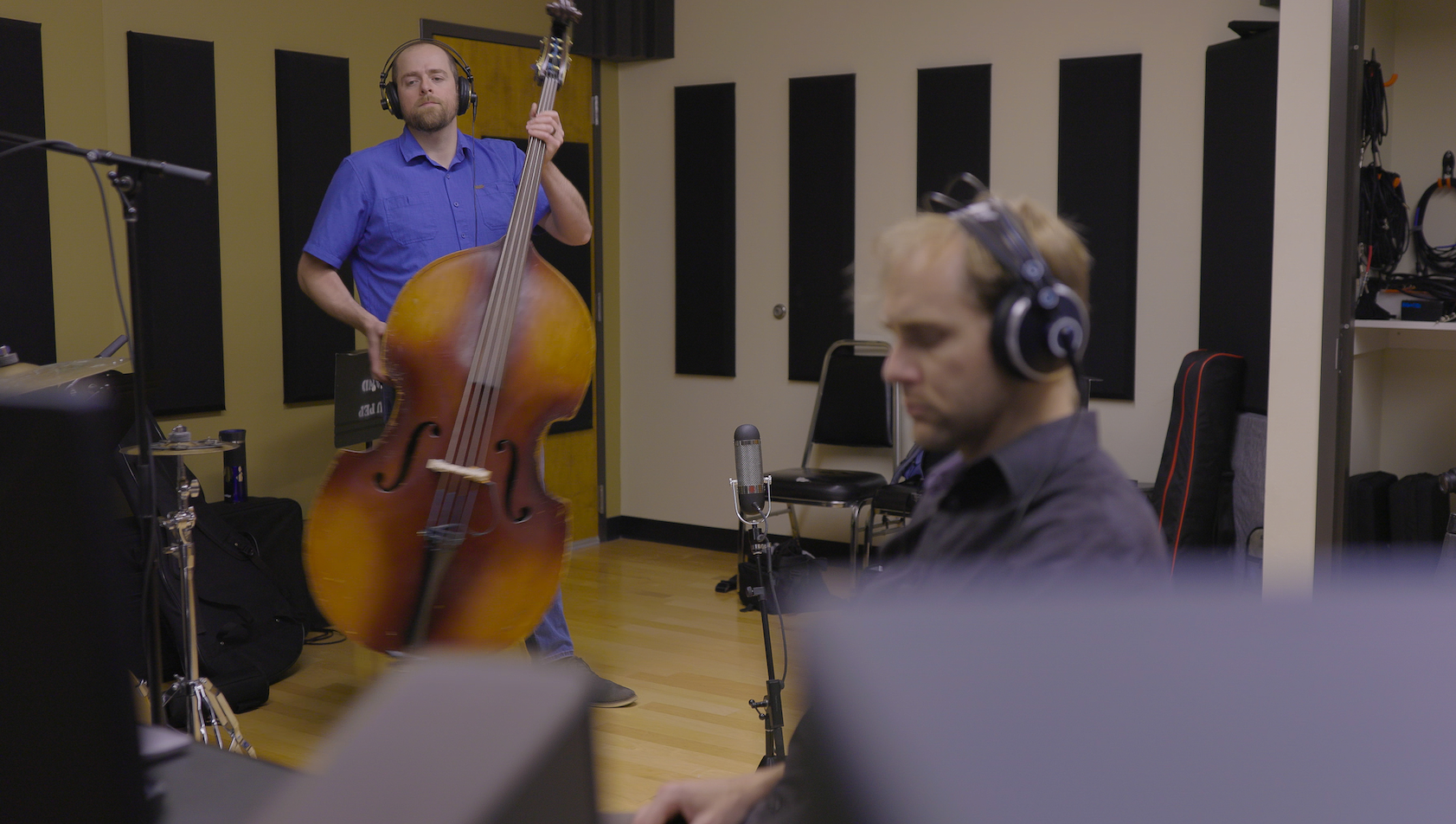 Jon Armstrong, associate professor of music and director of jazz studies at Idaho State University, and Paul Bodily, assistant professor of computer science at ISU, listen to a take during the recording session of “And I Think I.”