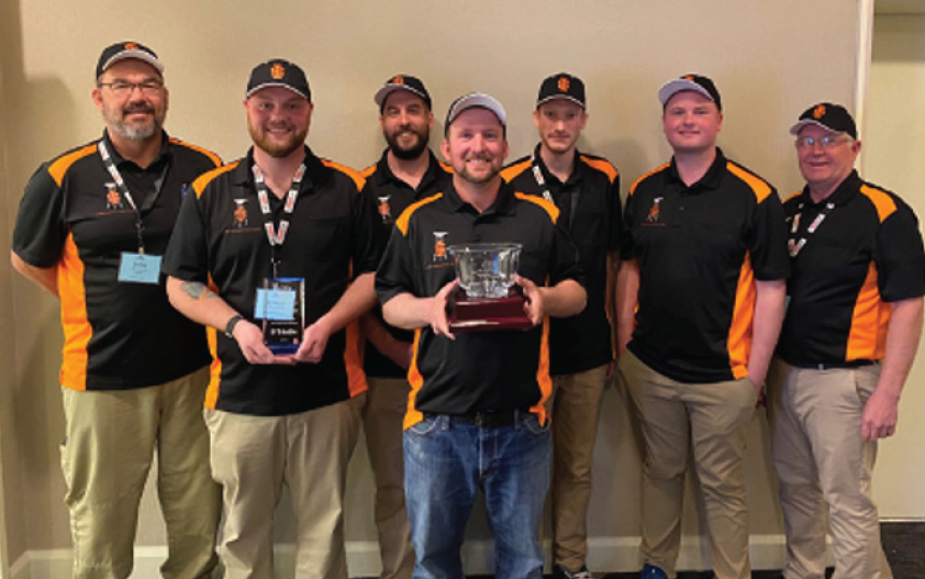 Students from the surveying program pose with their trophy