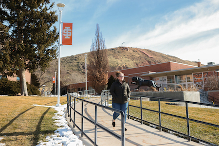 A student walks across the ISU Quad