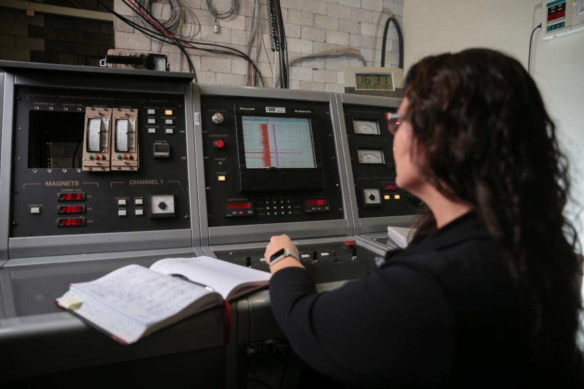 A woman looking at a nuclear console