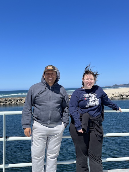 A man and woman stand on a ship deck