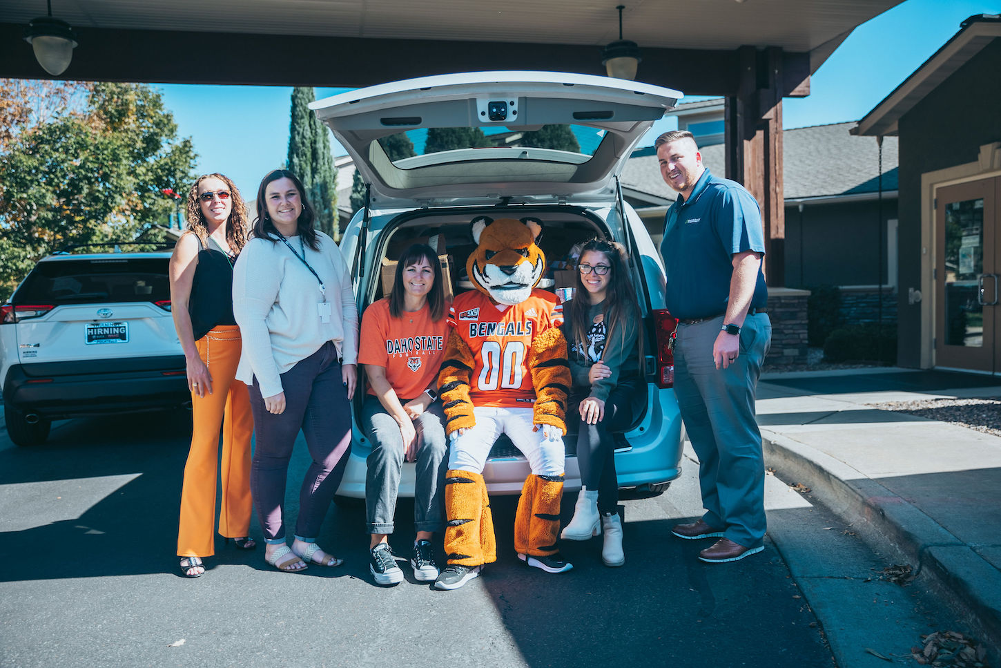 Benny Bengal and students sit in a van