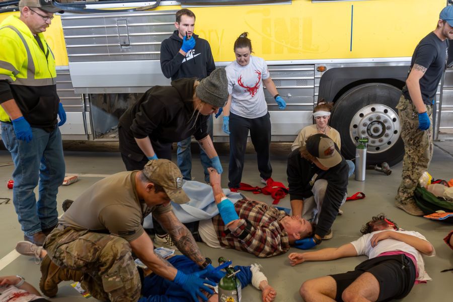 EMT simulation with theatre students and first responders at a mock crash site involving a bus