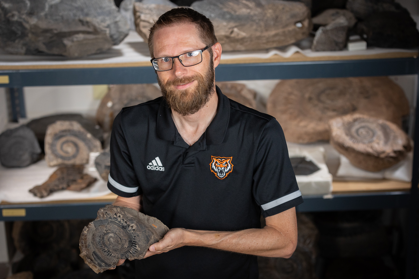 Leif Tapanila holding a fossil