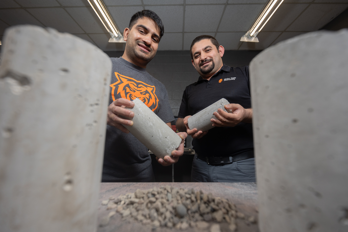Two men hold concrete samples