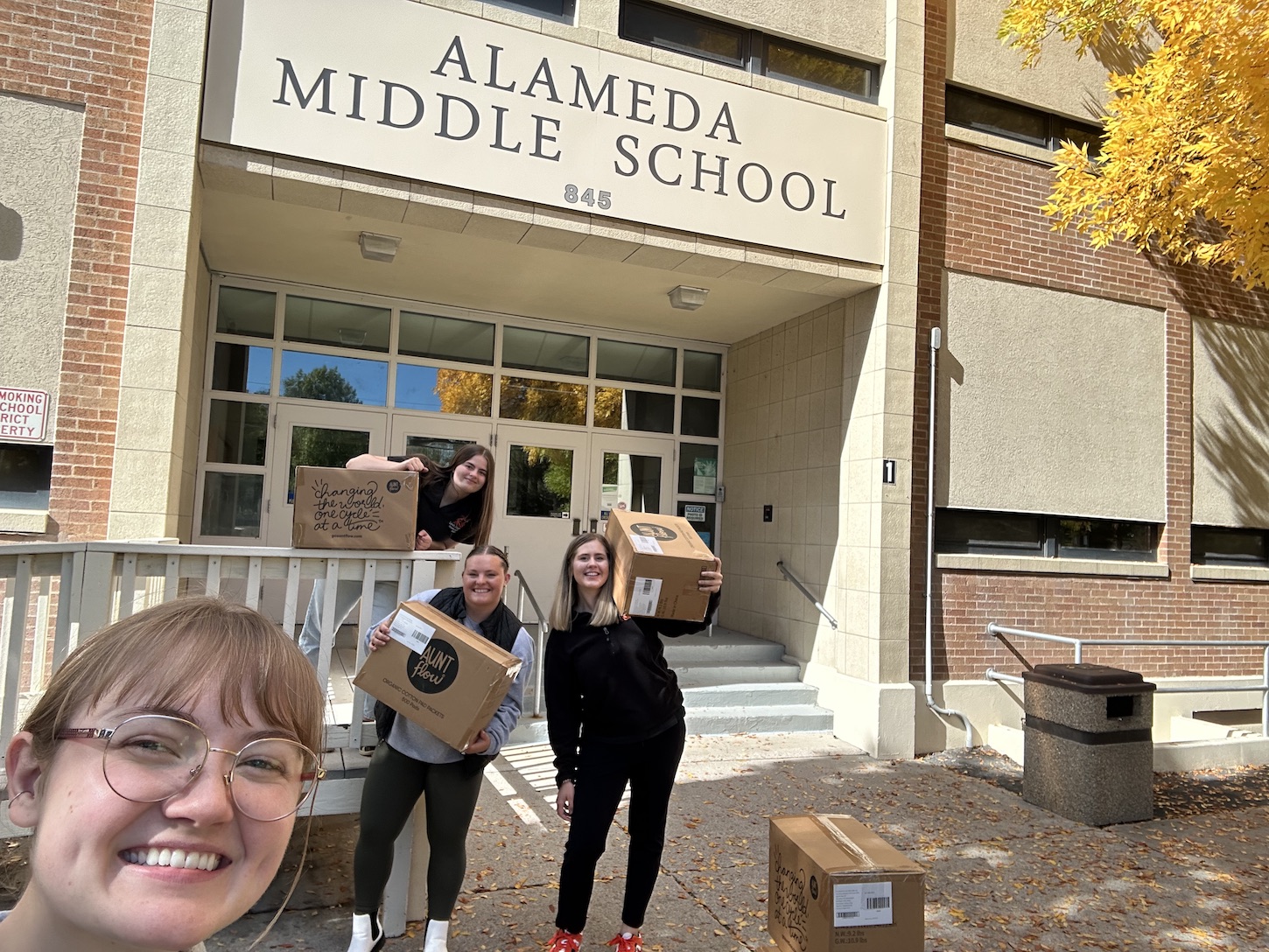 Three Women sit on boxes