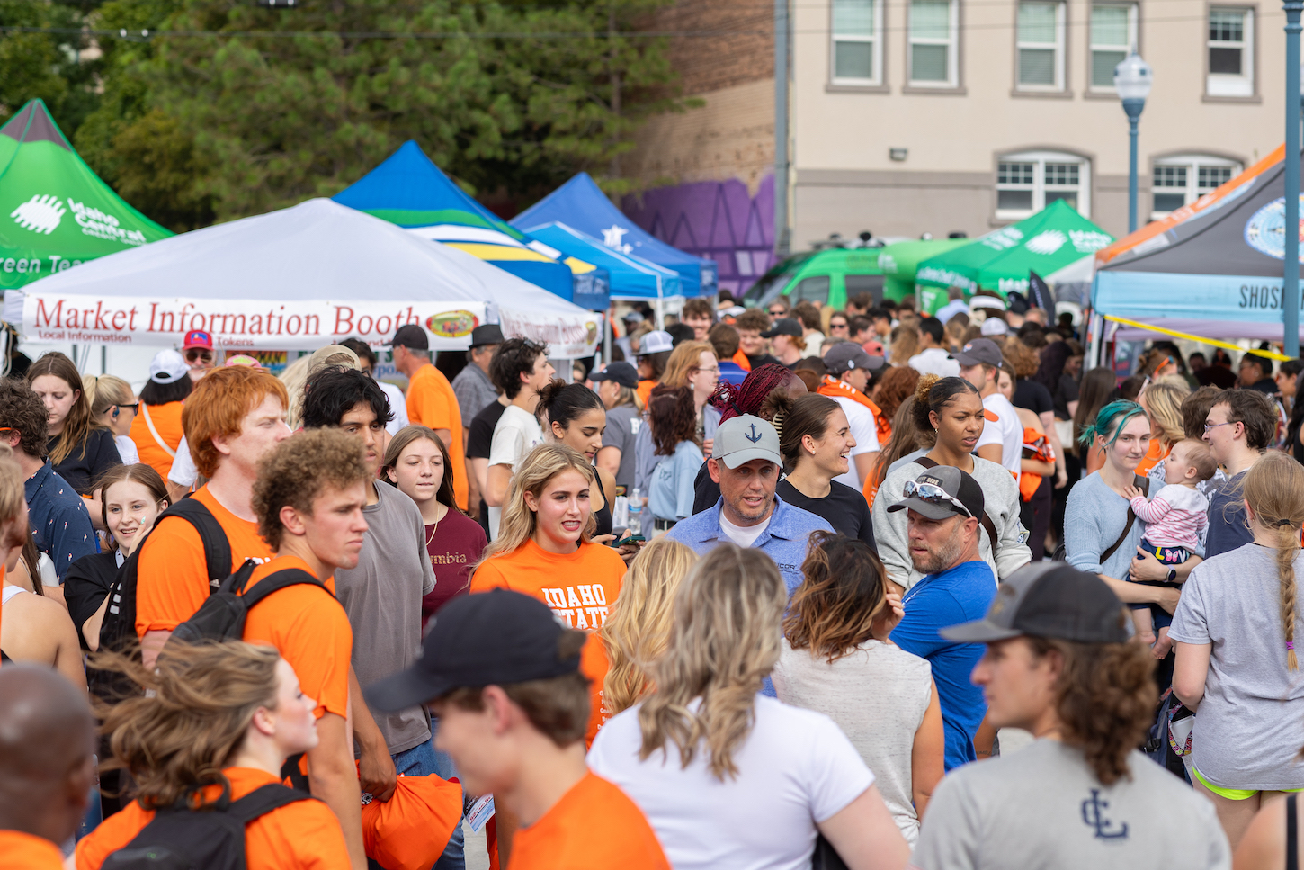 A crowd of people fill a street