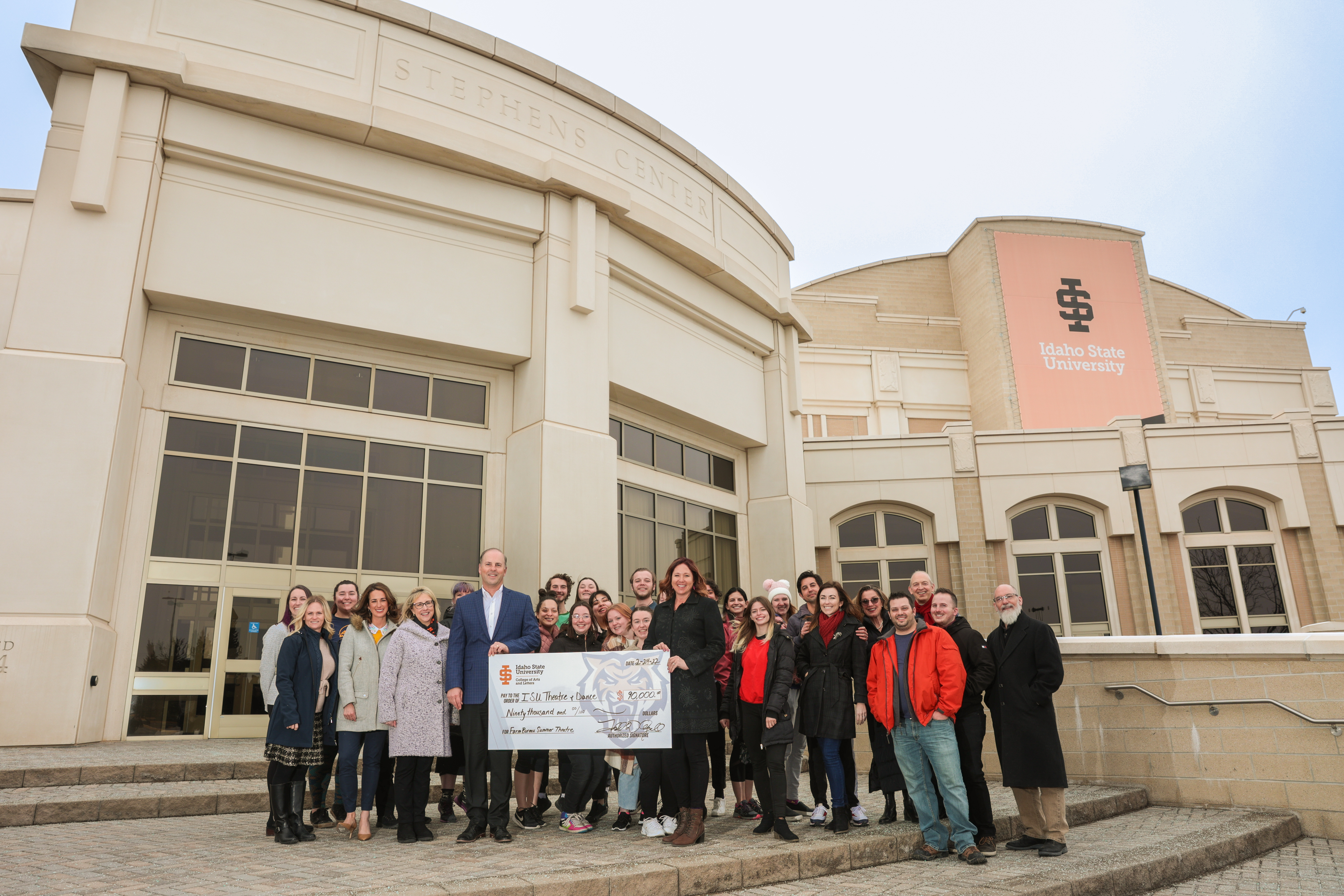 Farm Bureau and ISU representatives outside Stephens Performing Arts Center with giant donation check.