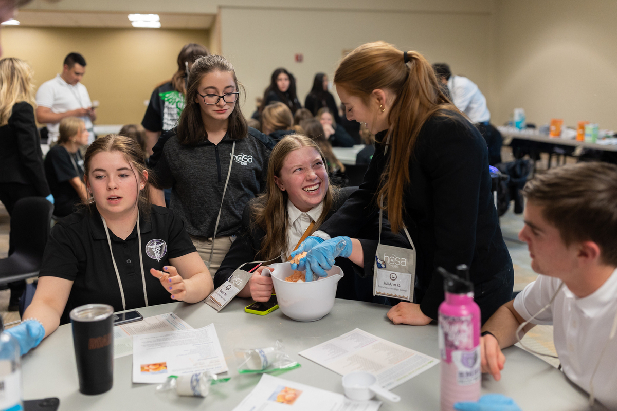 Four girls work on a science experiment