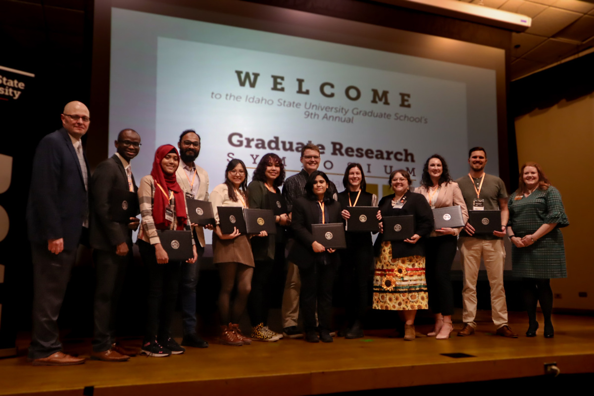 A group of students stand on a stage