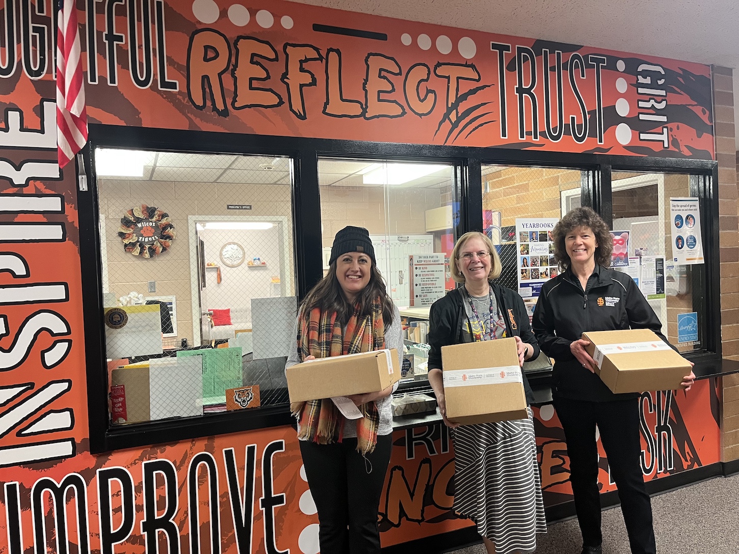 A group of women hold boxes