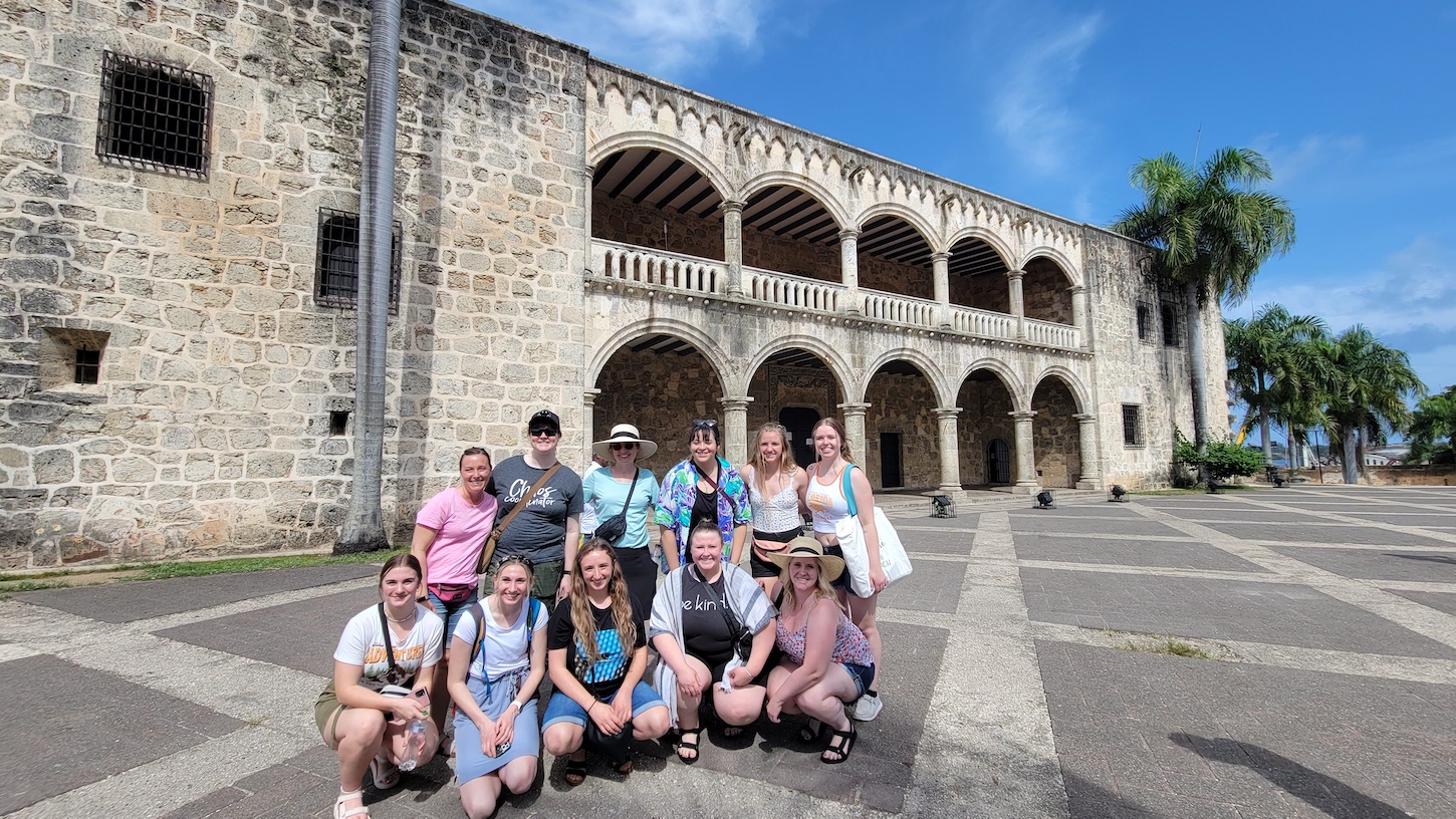 Students in a group photo outside some ruins