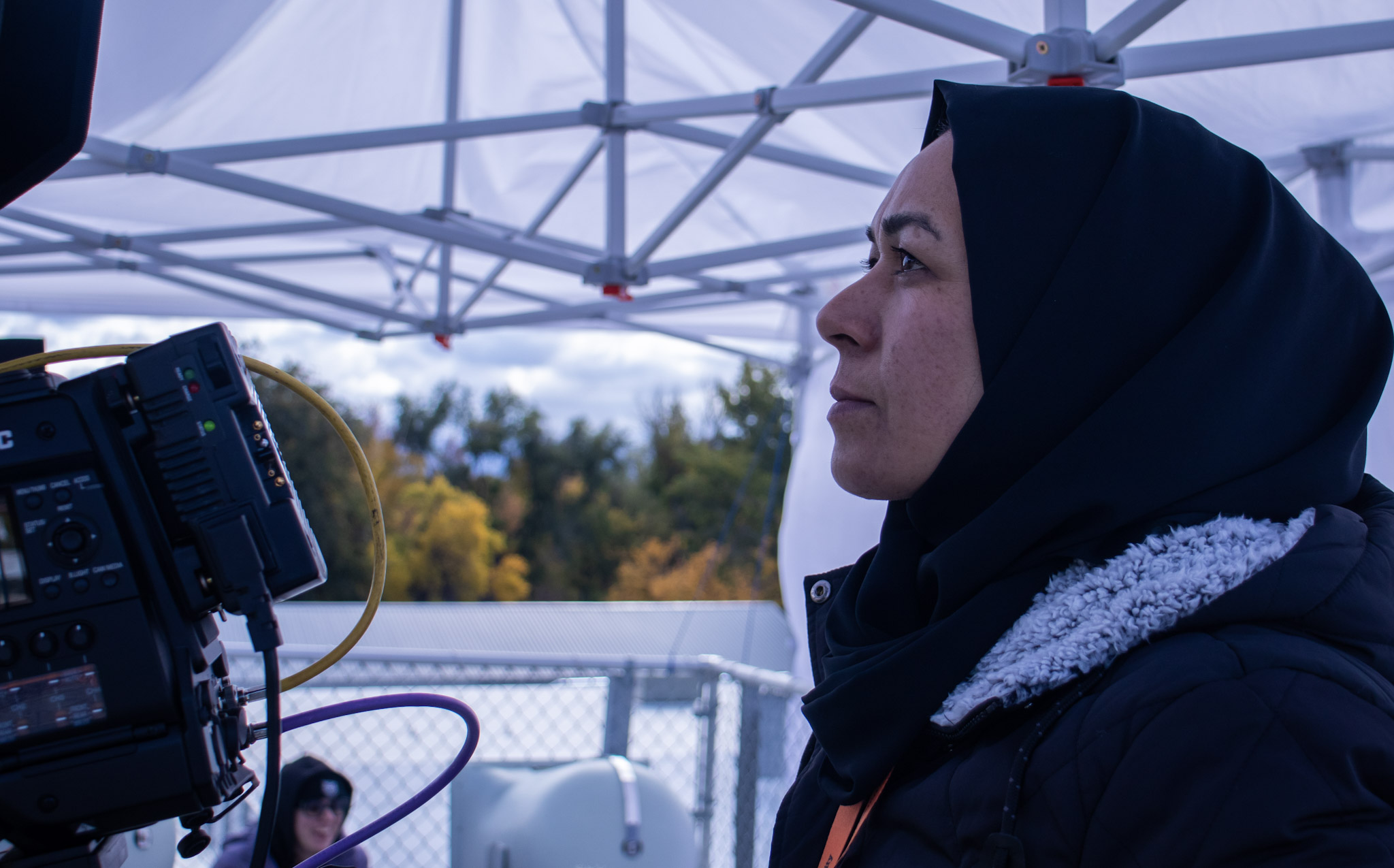 A woman looks into a video camera