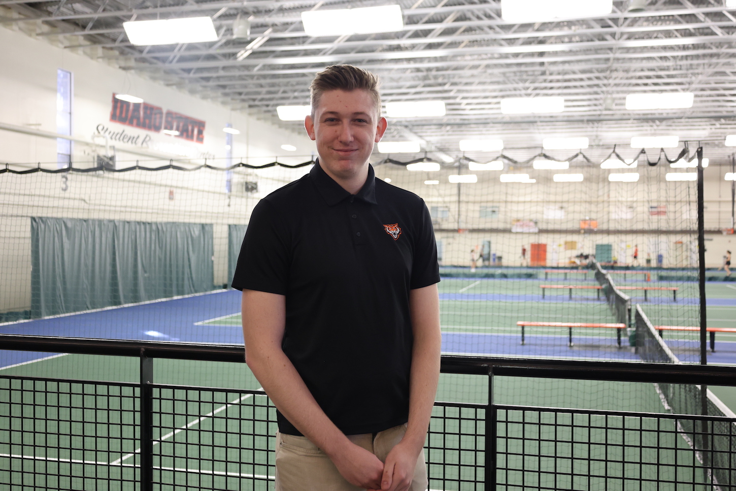 Tyler Moerer stands on a walkway.