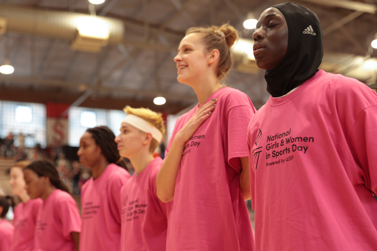 Four members of the ISU Womens' basketball team stand for the national anthem.