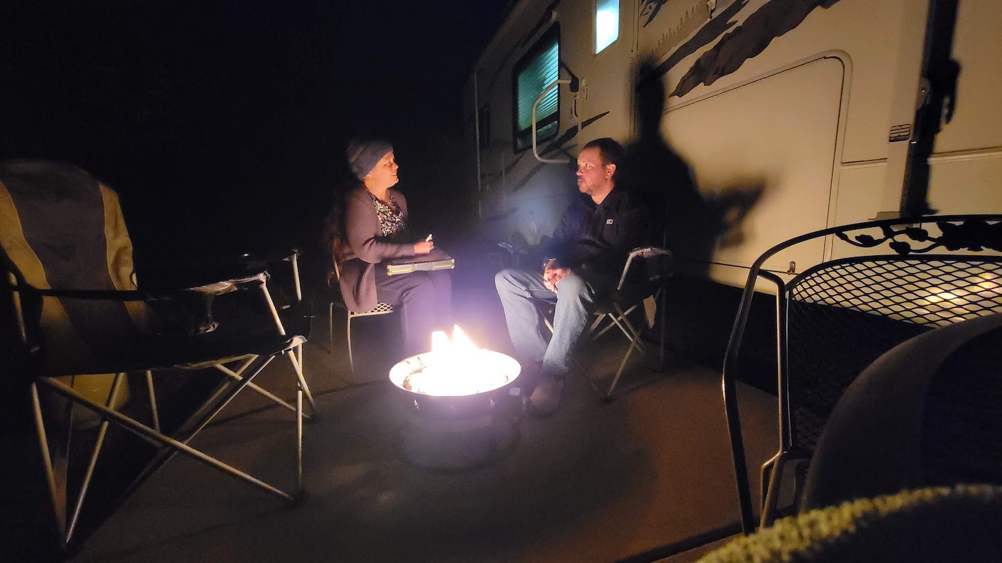 Ruth Tretter and a man at a campfire