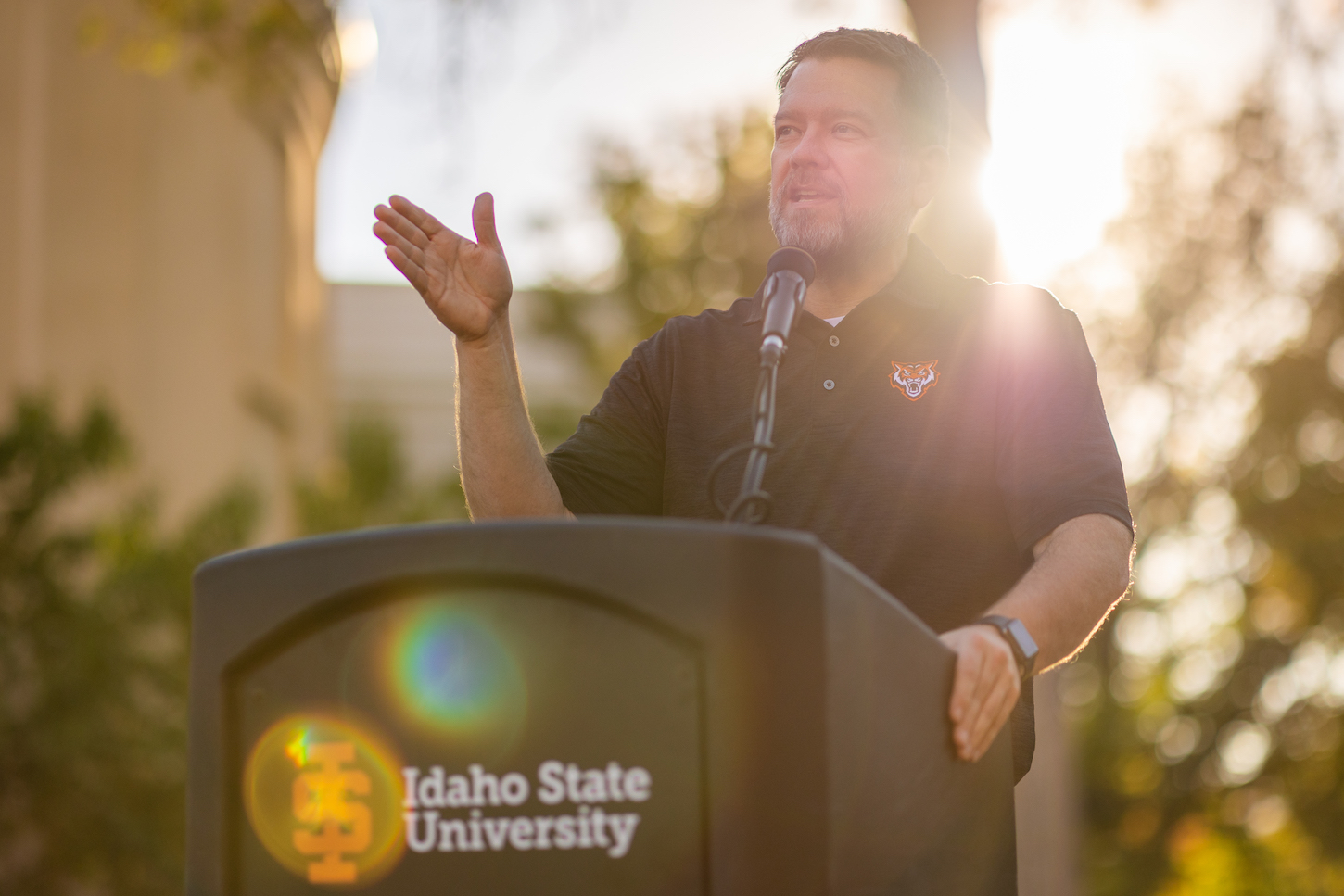 Kevin Satterlee stands at a podium outside