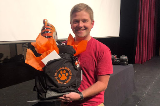 Jaxon Jensen holds a bag of ISU things