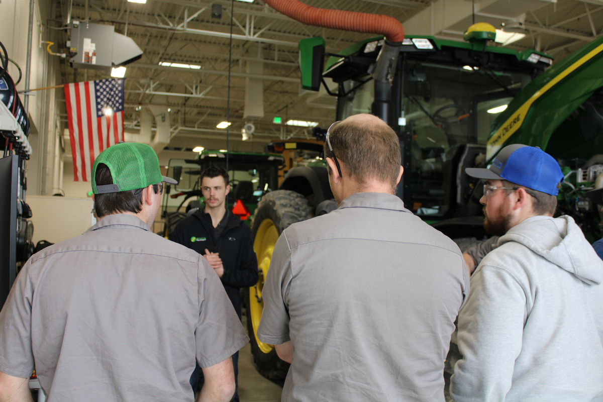 A group of students stand by equipment