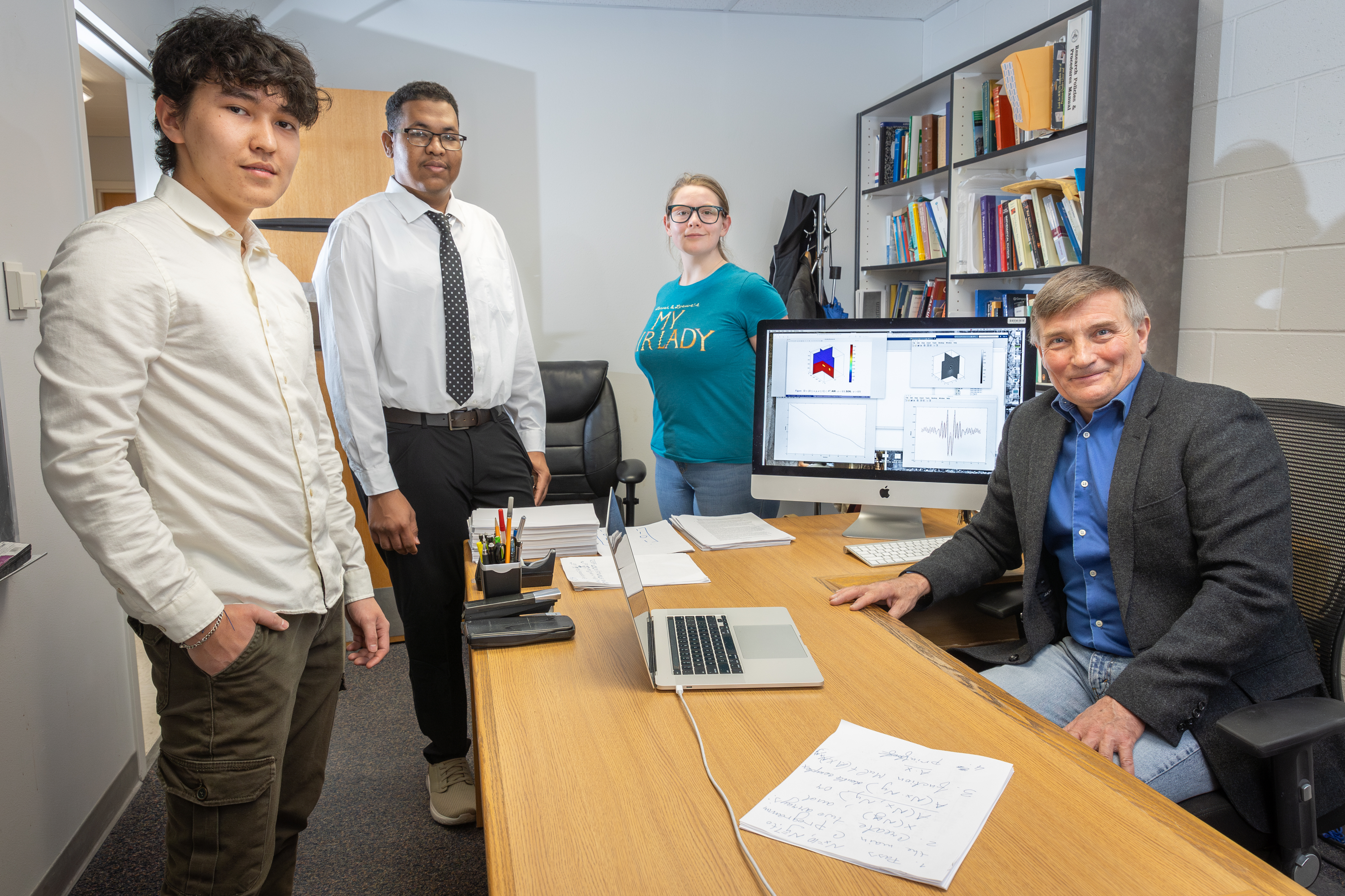 From left, Idaho State University students Bektur Akkabakov, Adil Ahmed, Isabella Dougherty, and Idaho State University Professor Yury Gryazin pose for a photo in Gryazin’s office on ISU’s Pocatello campus.