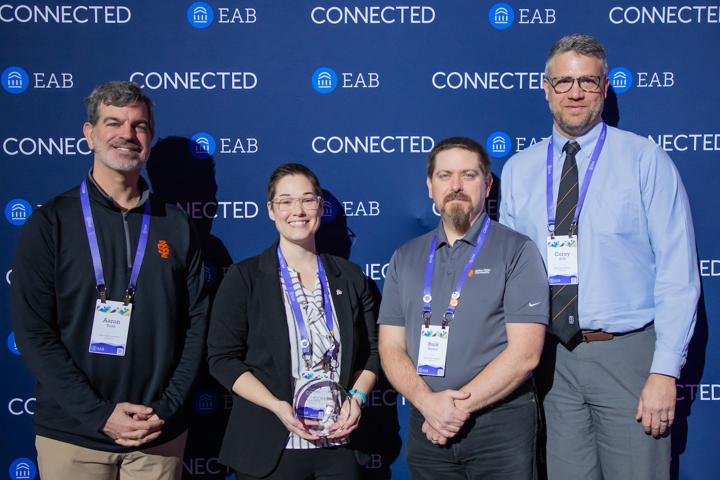 A group shot of people with an award