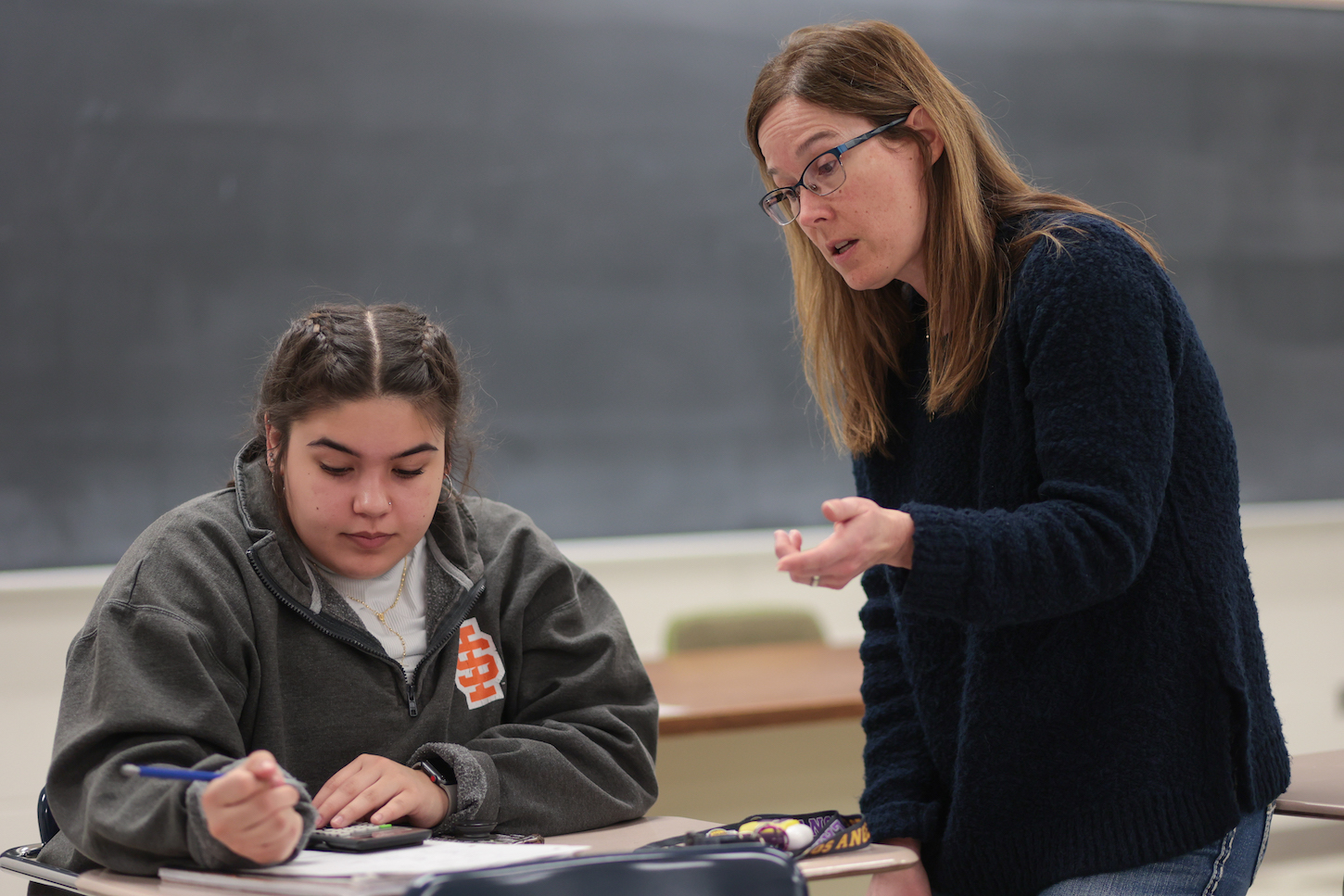 Annik Martin stands near a student