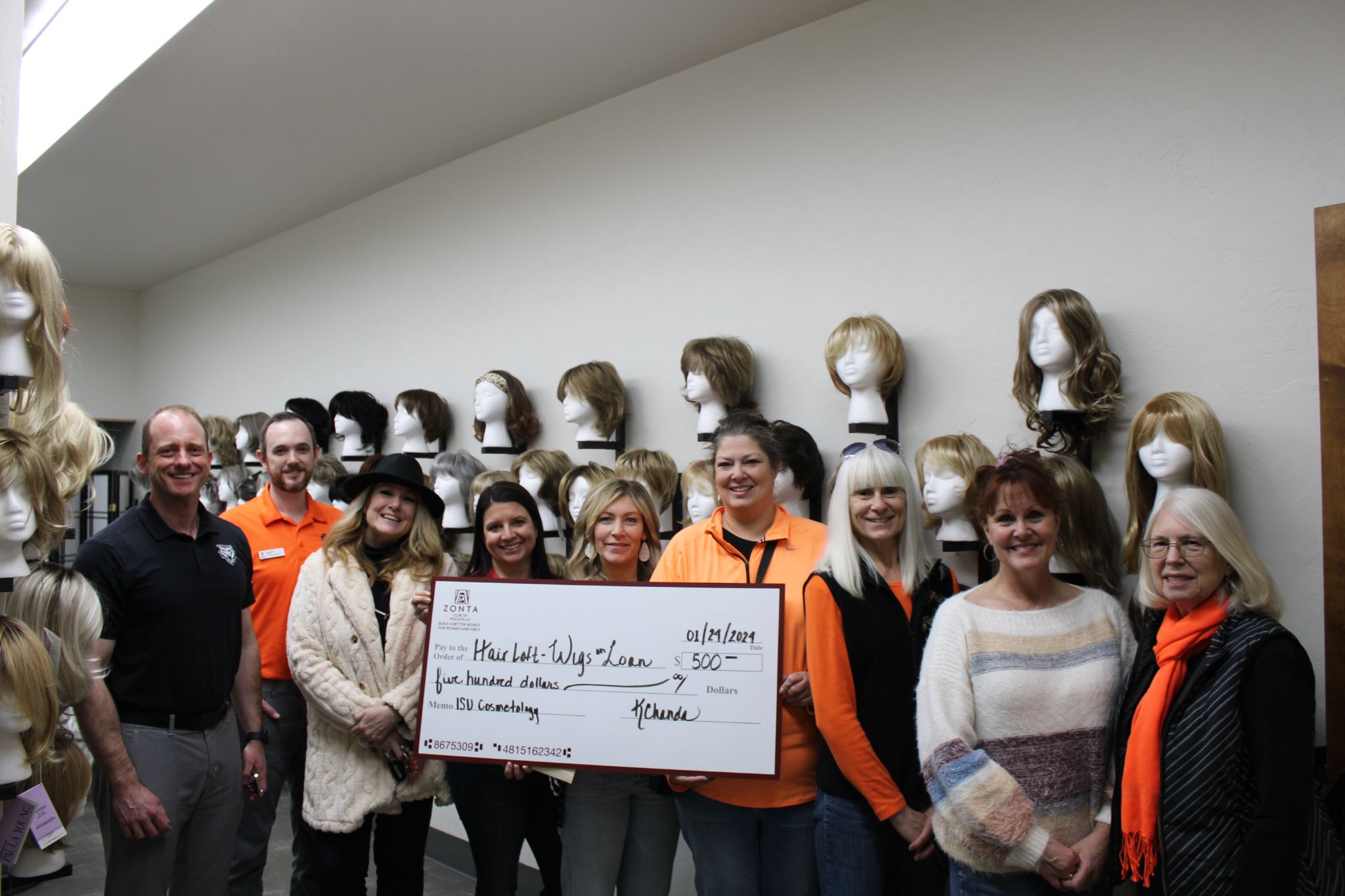 Zonta Club of Pocatello members with Hair Loft staff and several custom wigs