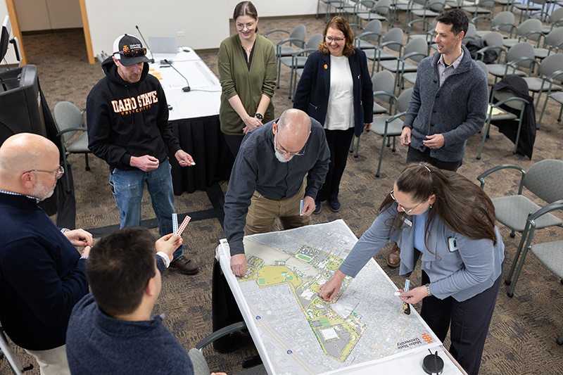 Campus master planning session with faculty and staff marking dots on a campus map