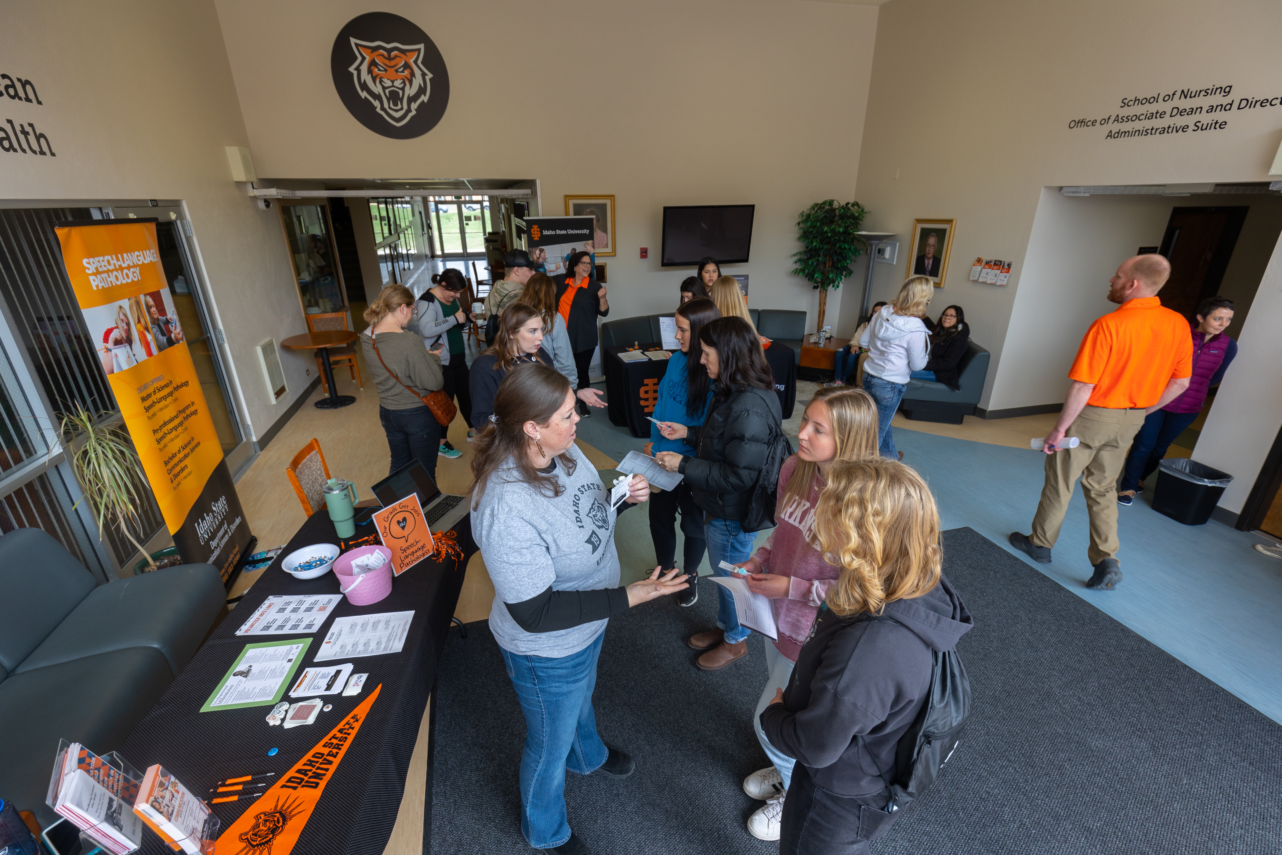 Students in the lobby of Beckley Nursing Building at Bengal Visit Day talking with other students