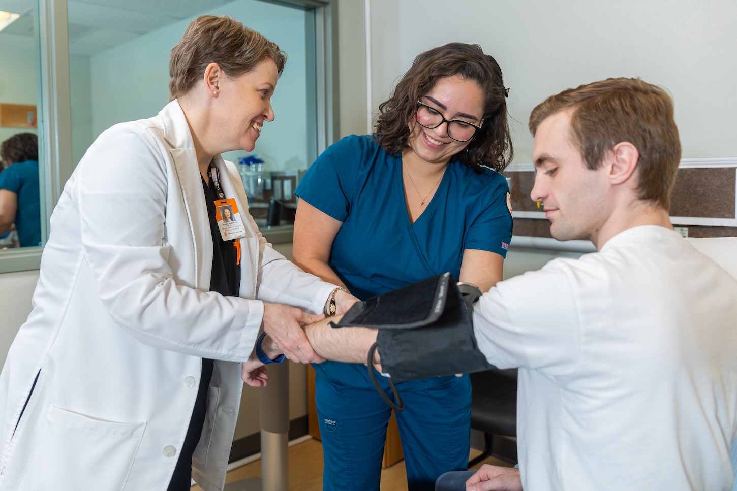 A nurse checks blood pressure
