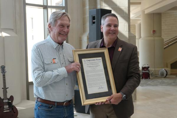 President Robert Wagner with Congressman Mike Simpson holding a plaque