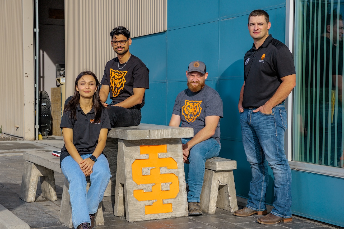 A group of students at a cement picnic table