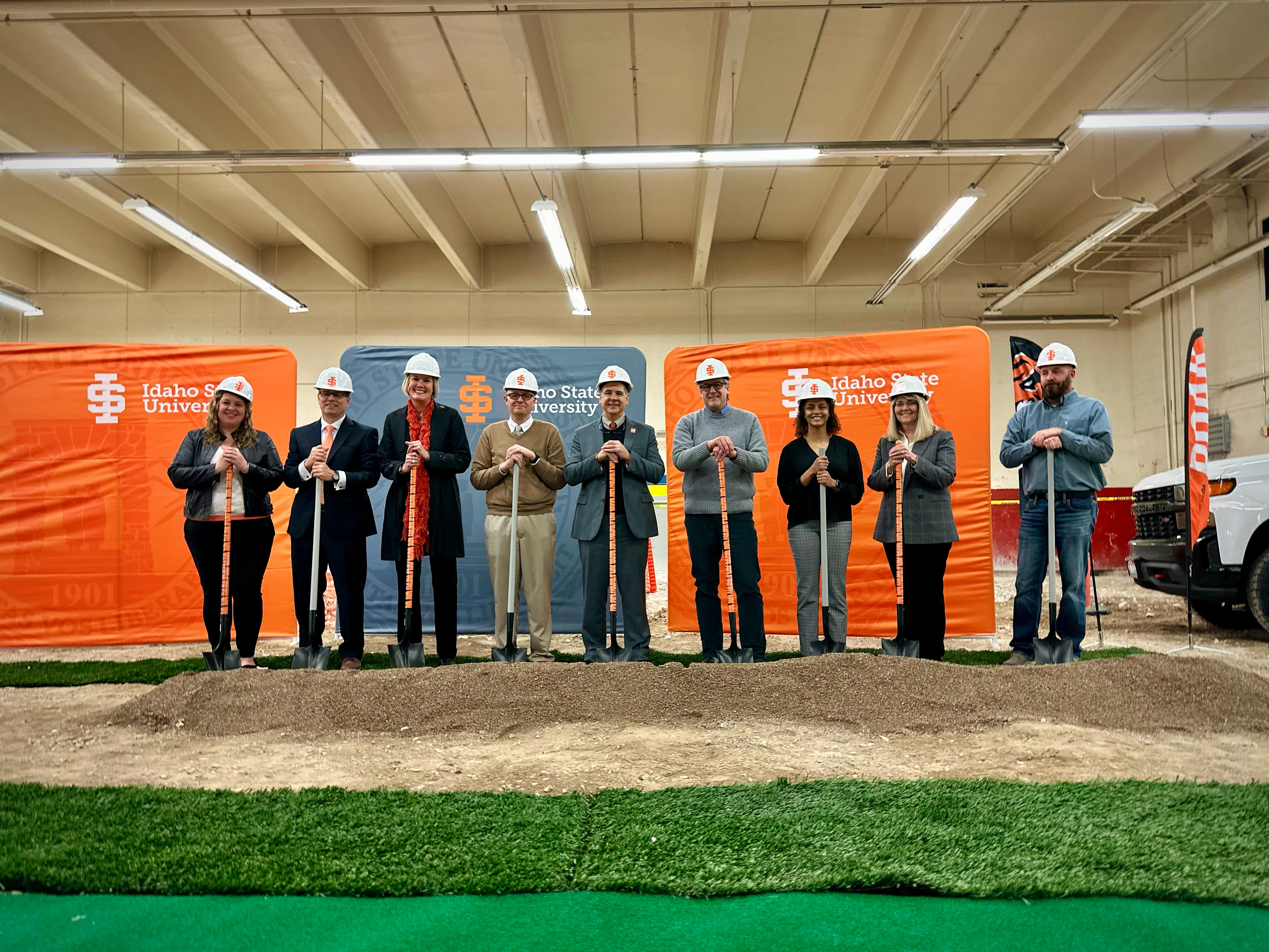 Groundbreaking event for renovations at RFC with dignitaries in hard hats and holding shovels.