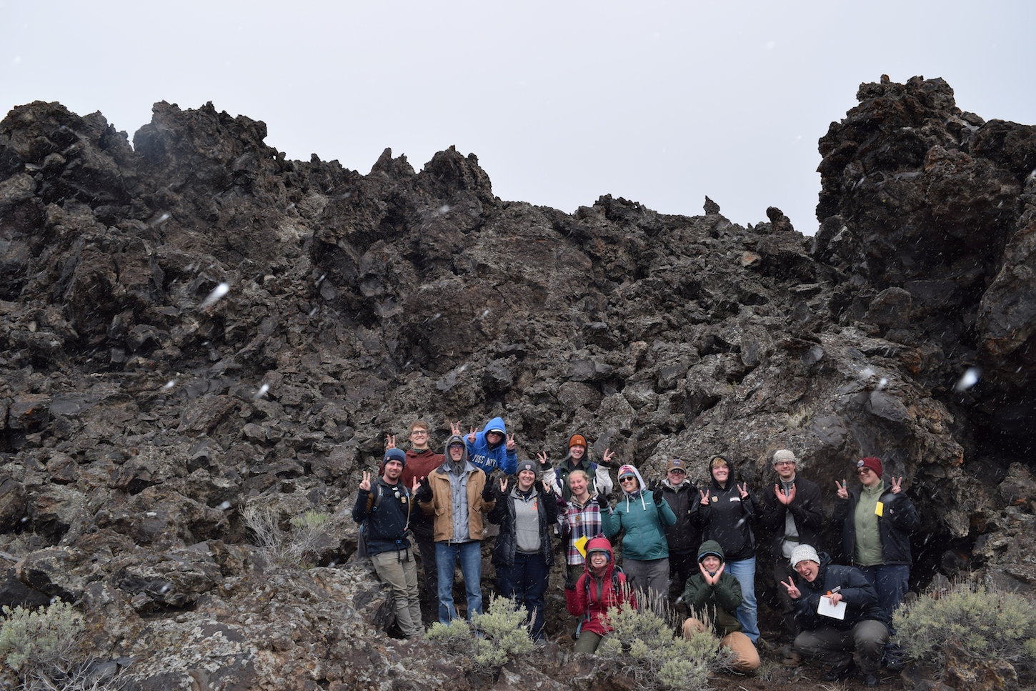 A group of students by lava rocks