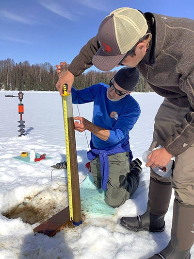 Bruce Finney (left) and Brad Baxter (right) measuring sediment retrieval.