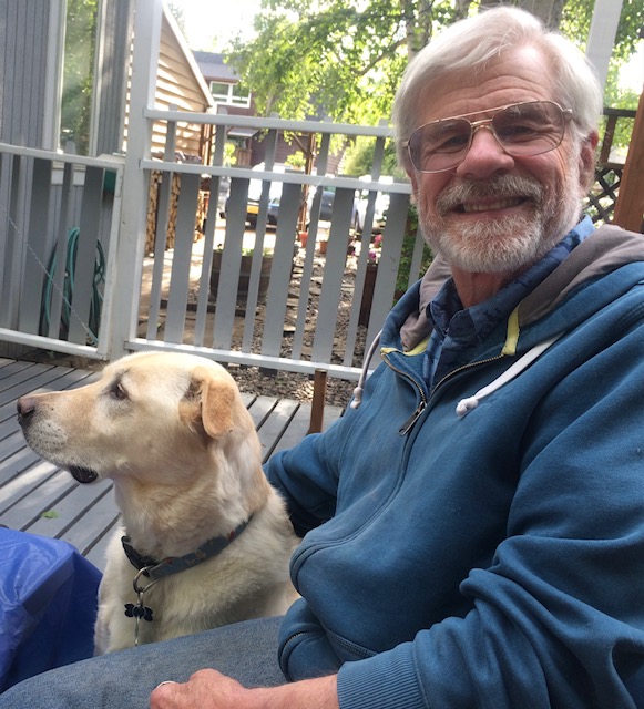 A photo of Walter T. Smith and a dog named Pinot.