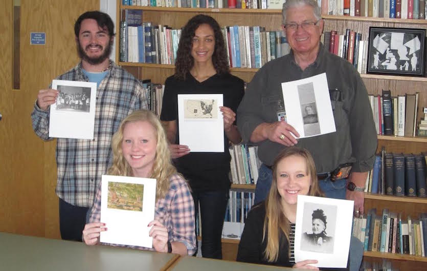 A photo of members of Dr. Erika Kuhlman's Women in the North American West history course holding images derived from their research. Pictured standing are, from left, Les Miller, DiSeanna Kilgore, Jim Payne. Pictured seated are Samantha Jackson and Molly Draben.
