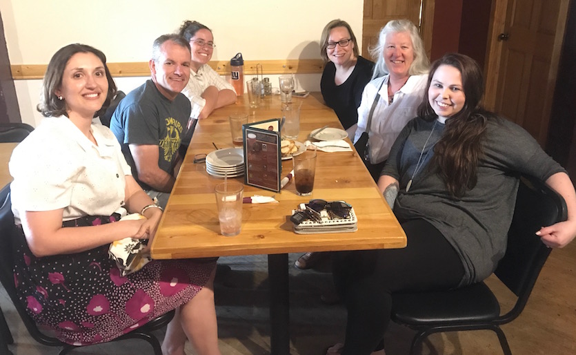 Photo of six researchers involved in the project sitting at a table. 