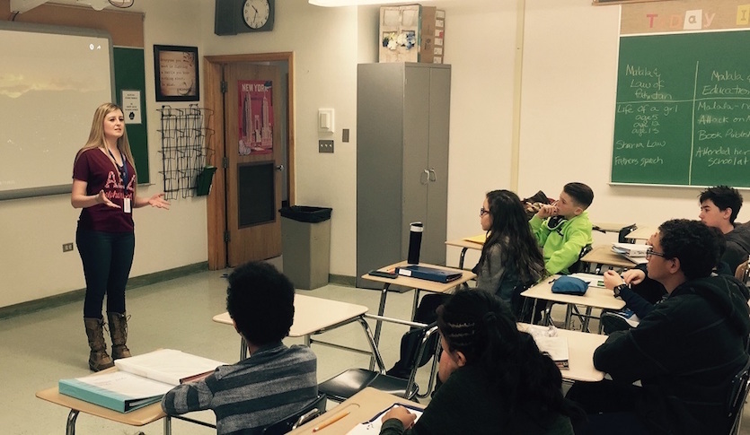 Picture of CPI intern Abby Latta teaching in front of a class of students.