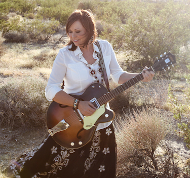 Suzanne Bogguss playing the guitar.